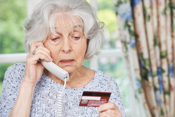 Elder fraud - Senior Woman Giving Credit Card Details On The Phone