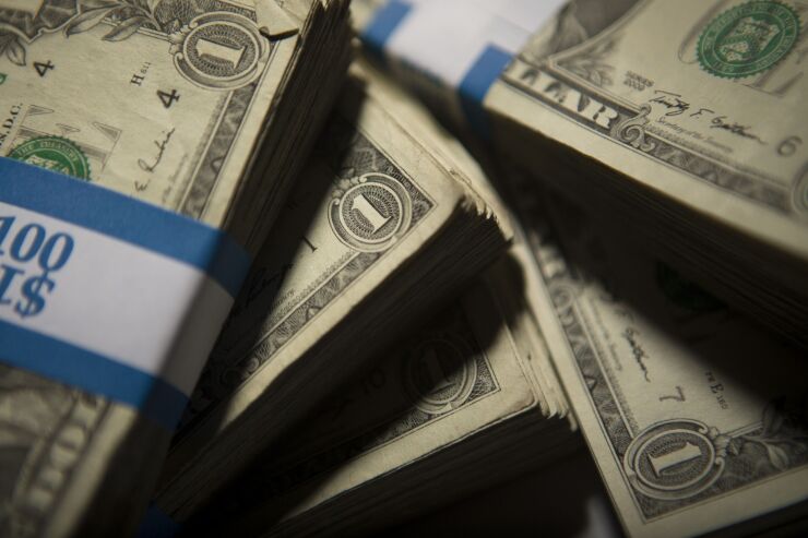 Americans Over 70 Hold More Than 30% of the Country's Wealth - Bloomberg. Dollar bill stacks.